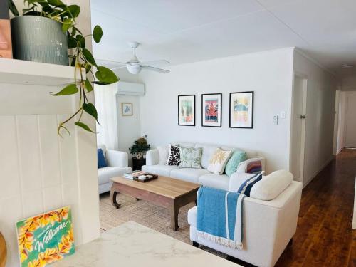 a living room with a white couch and a table at Halia in Gold Coast
