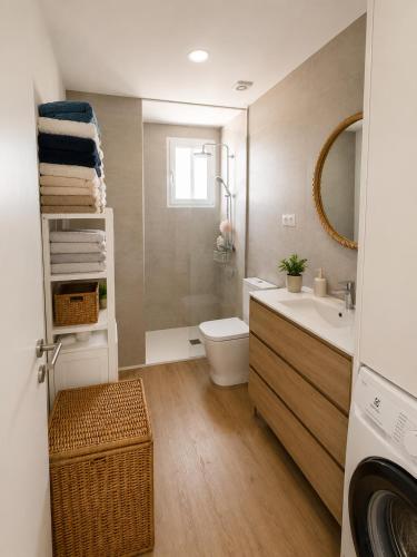 a bathroom with a sink and a toilet and a sink at Waves beach house in Viana do Castelo