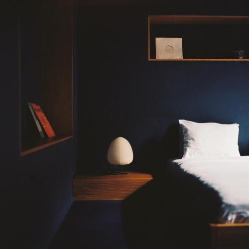 a bedroom with a bed and a lamp on a table at Blueberry Nights in Tbilisi City