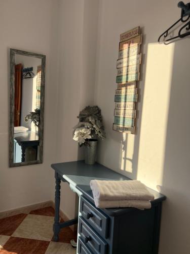 a blue desk in a room with a mirror at Casas PARAJE NATURAL in Zahara de la Sierra