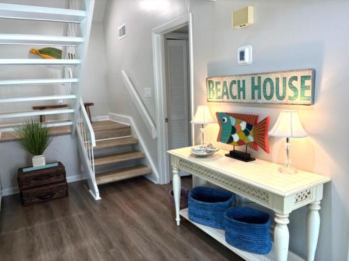 a room with a desk and a stair case at 767 Spinnaker Beach House in Seabrook Island