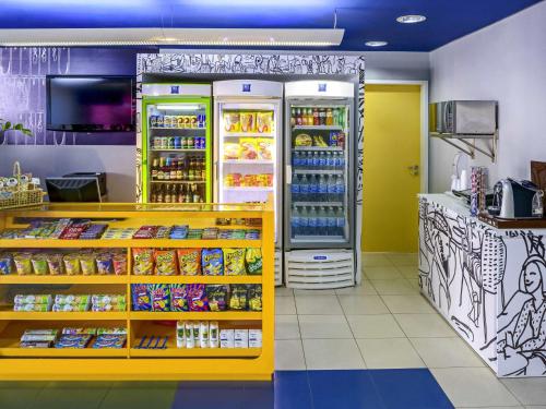 a grocery store with a refrigerator with food and drinks at ibis budget Belem in Belém