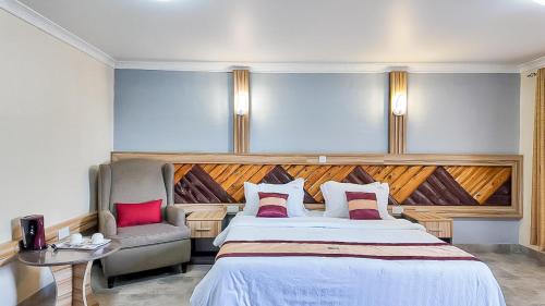 a bedroom with a large bed and a chair at The Luke Hotel - Roasters in Nairobi