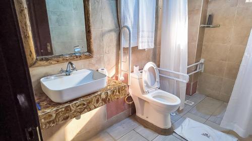 a bathroom with a sink and a toilet at The Luke Hotel - Roasters in Nairobi