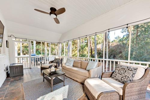 a living room with a couch and chairs and windows at 2713 Seabrook Island Road in Seabrook Island