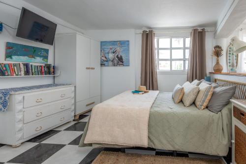 a bedroom with a bed and a dresser at Vista Paraiso, Sea breeze facing the sea in La Oliva