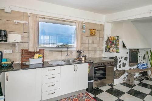 a kitchen with a sink and a window at Vista Paraiso, Sea breeze facing the sea in La Oliva