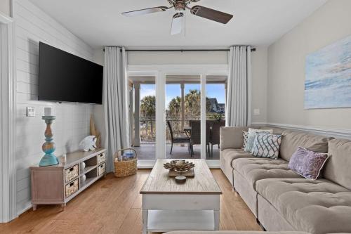 a living room with a couch and a table at 2943 Atrium Villa in Seabrook Island