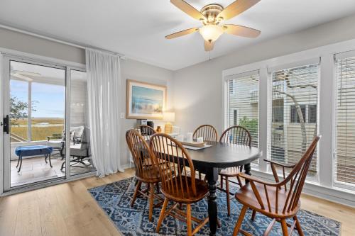 a dining room with a table and chairs and a ceiling fan at 1807 Heron Pt in Seabrook Island