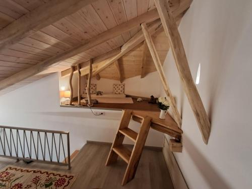 a room with a desk in a loft with wooden beams at Aegean Infinite View-Beachfront Suite Pelion in Chorefto