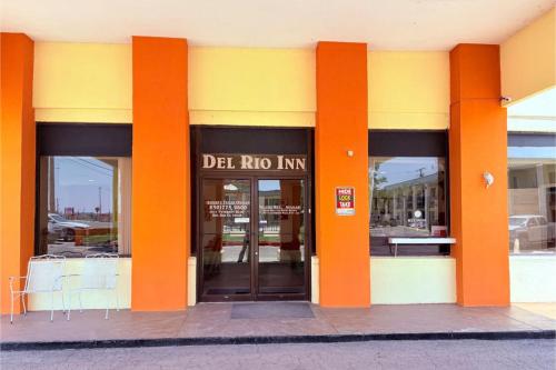 a building with orange columns on the front of it at Del Rio Inn TX By Hotel O in Del Rio
