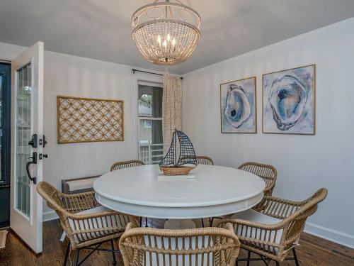 a dining room with a white table and chairs at 1129 Summerwind Cottage in Seabrook Island