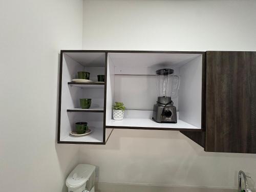 a cupboard with a blender on a wall at alojamientos la martina in Cali