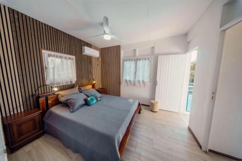 a bedroom with a bed and a ceiling fan at Haut de lolo in Garnier