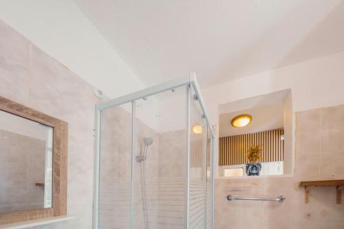 a bathroom with a shower with a glass door at Haut de lolo in Garnier