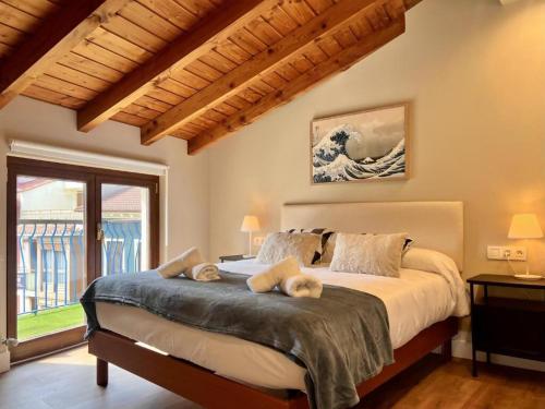 a bedroom with a large bed and a large window at Kantauri Homes- KAI in Bermeo