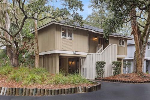 a large house with trees in front of it at 1128 Summerwind Cottage in Seabrook Island