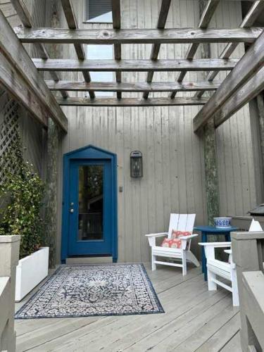 a patio with a blue door and two chairs at 2264 Seascape Crt. in Seabrook Island