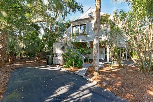 a white house with trees in front of it at 804 Treeloft Cottage in Seabrook Island