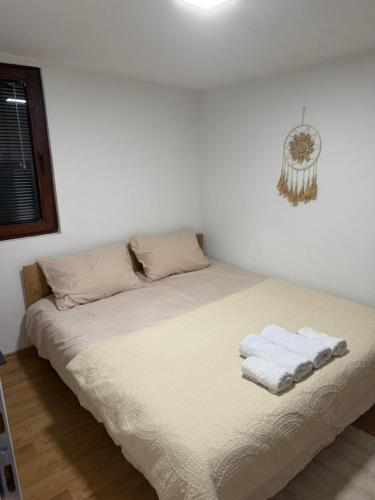 a bed in a room with two towels on it at Dorotea Apartment in Ohrid