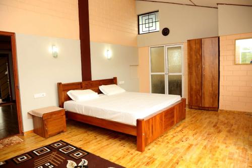a bedroom with a large bed in a room at sunshine retreat in Coonoor