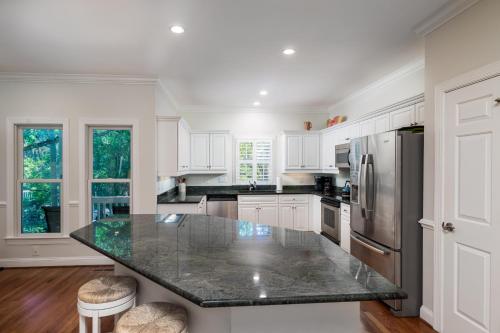 a kitchen with white cabinets and a black counter top at 1006 Crooked Oaks in Seabrook Island
