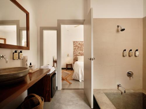a bathroom with a sink and a shower at Hotel Los Patios - Parque Natural in Rodalquilar