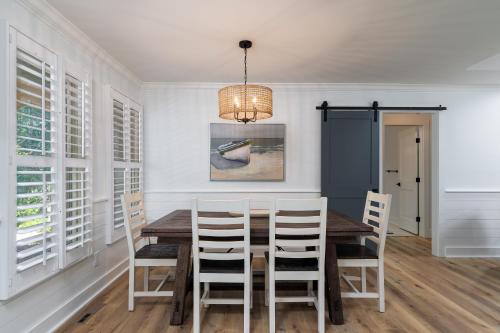 a dining room with a table and chairs at 1147 Summerwind Cottage in Seabrook Island