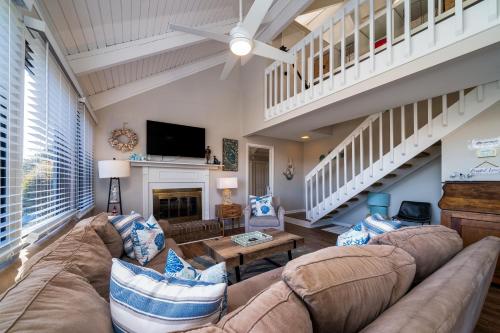 a large living room with a couch and a tv at 815 Treeloft Cottage in Seabrook Island