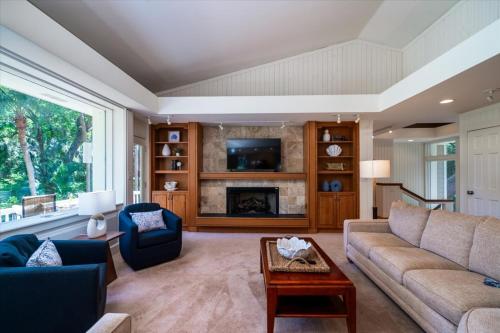 a living room with a couch and a fireplace at 2710 Gnarled Pine in Seabrook Island