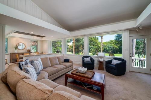 a living room with a couch and chairs and windows at 2710 Gnarled Pine in Seabrook Island