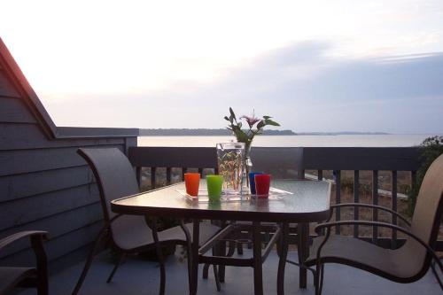 a table on a balcony with a view of the ocean at 1340 Pelican Watch Villa in Seabrook Island