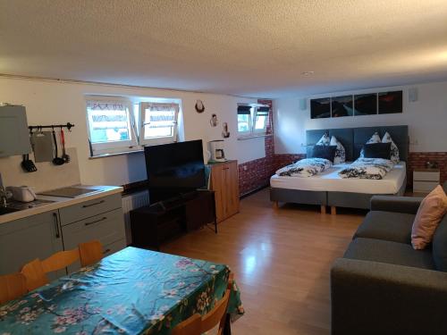 a living room with a couch and a bed in a room at Ferienwohnung in Espenau