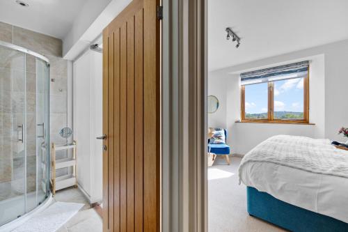 a bedroom with a bed and a glass shower door at Pitstop in Dartmouth