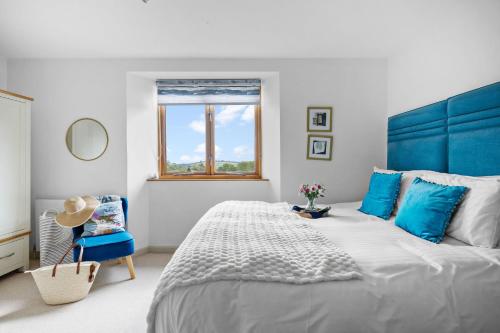 a bedroom with a large bed and a blue headboard at Pitstop in Dartmouth