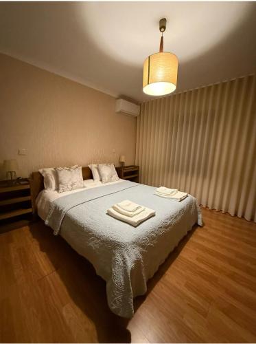 a bedroom with a bed with two towels on it at Varandas do Tamega in Mondim de Basto