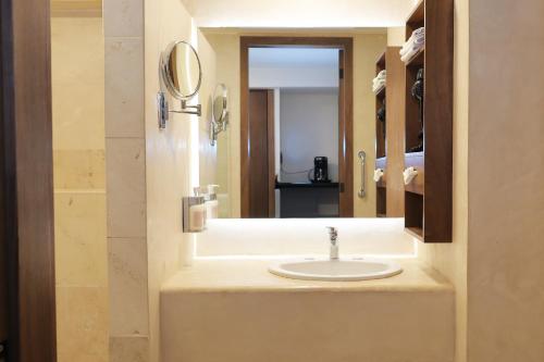 a bathroom with a sink and a mirror at Hotel Fortin Plaza in Oaxaca City