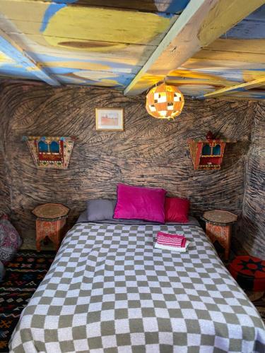 a bedroom with a bed in a room at The Mud House in Tamraght Ouzdar