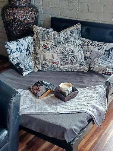 a bed with a tray with a cup of coffee on it at Duncan Garden Cottage in Brakpan