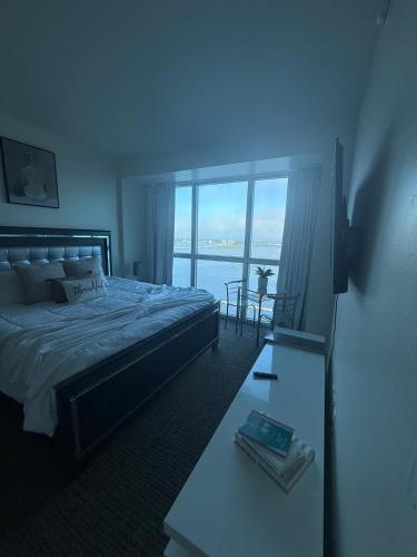 a bedroom with a bed and a view of the ocean at Luxury II in Fort Myers