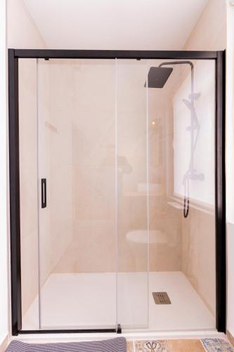 a glass shower stall in a room at Casa Bubela- Vía de la plata in Dozón
