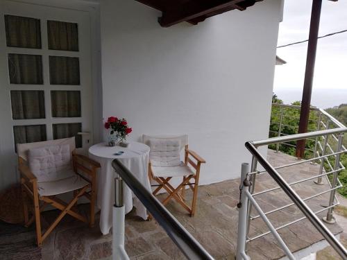 a table and two chairs on a porch at Mama's home in Arethousa