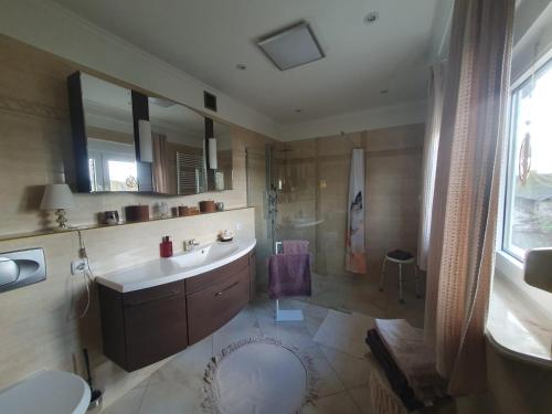 a large bathroom with a sink and a shower at White House in Gronów