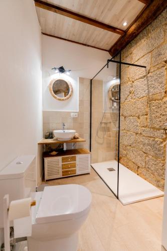 a bathroom with a toilet and a sink at Casa Bubela, O Castro de Dozón. in Dozón