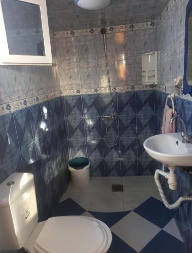 a bathroom with a toilet and a sink at Oumayma in Sousse