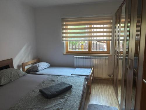 a bedroom with two beds and a window at Vila Sultan Sarajevo in Sarajevo