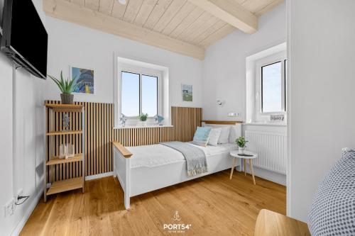 a bedroom with a bed and two windows at Ferienhaus Philomena Dagebüll in Dagebüll