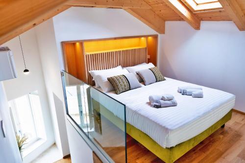 a bedroom with a bed with two pillows on it at Marmori Suites Cagliari in Cagliari