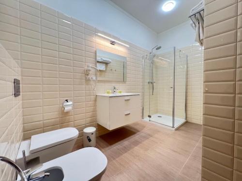a bathroom with a toilet and a shower and a sink at D31 Hotel in Odesa