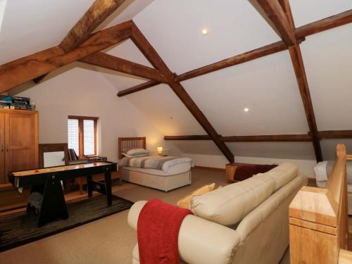 a living room with a couch and a table at Longside in Abergavenny